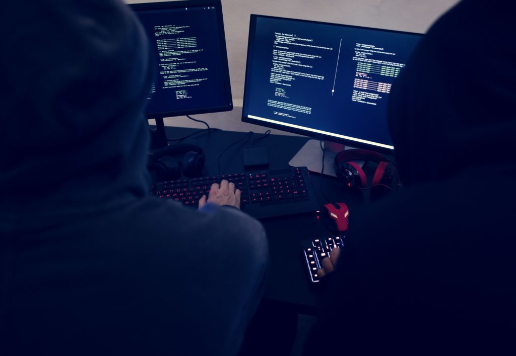 Hacker programmers coding in computers